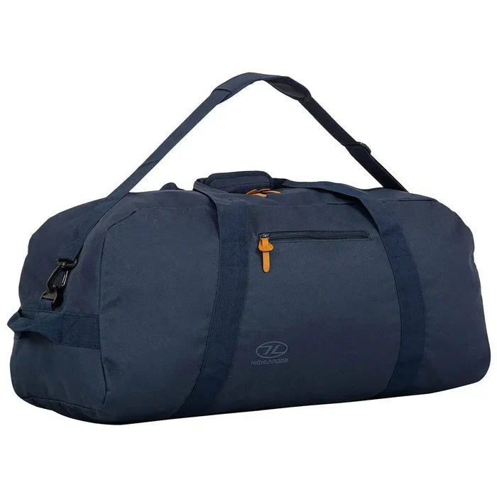 Side view of the Highlander Cargo 100L Heavy Duty Bag in navy blue, showcasing an adjustable shoulder strap, durable handles, and a spacious main compartment. from John Bull Clothing