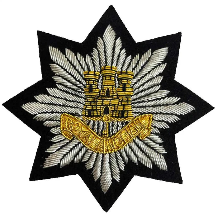 Royal Anglian Blazer Badge Wire Bullion featuring a gold castle emblem and 'Royal Anglian' banner on black felt, ideal for military uniforms. from John Bull Clothing