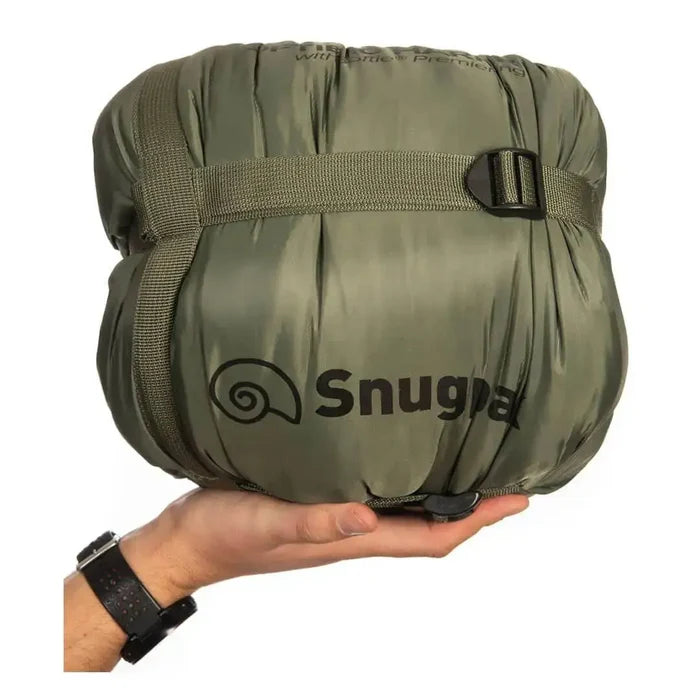 Compact packed Snugpak Softie 10 Harrier Sleeping Bag in olive green with logo, shown in hand for size reference, perfect for travel and hiking. from John Bull Clothing