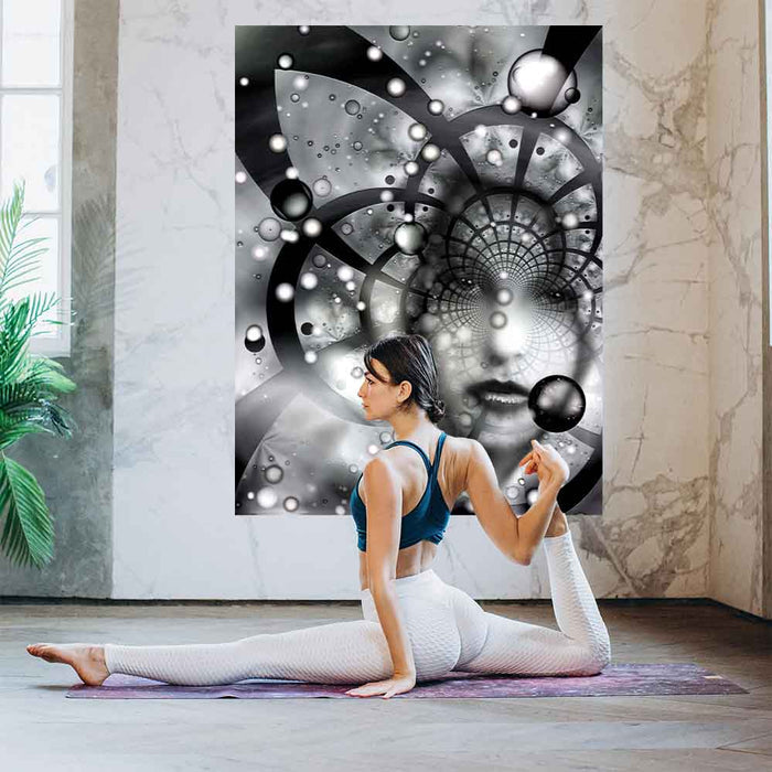 60 inch decal of an abstract black and white artwork capturing a striking face woven into a swirling tapestry of stars, nebulae, and cosmic energy installed on a wall with woman doing yoga in foreground