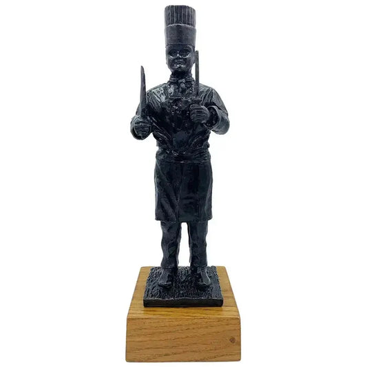 Army Chef Statue Bronze Resin | John Bull Clothing sculpture of a military chef holding utensils, mounted on a wooden base for home decor.  from  John Bull Clothing