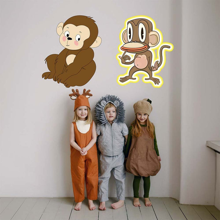 Children in animal-themed costumes standing in front of 24" wall decals of monkeys.