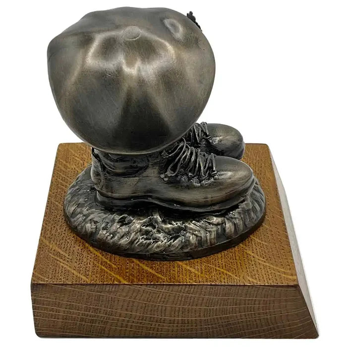 Angled back view of Beret and Boots Statue Bronze Resin on Oak Base | John Bulls, showing sculpted boot heels and beret folds.  from  John Bull Clothing