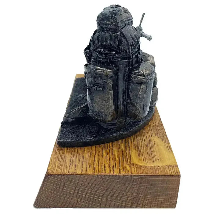 Side view of Bergen and SA80 bronze resin army statue showing intricate backpack details on solid oak base, ideal for military-themed decor.  from  John Bull Clothing