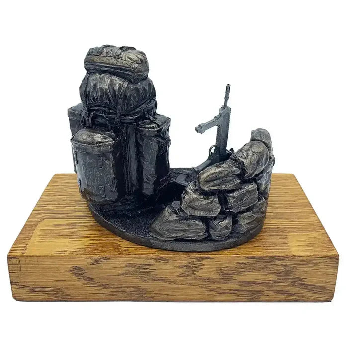 Rear angle of Bergen and SA80 bronze resin army presentation with sandbags and rifle, mounted on oak base for collectible or gift display.  from  John Bull Clothing