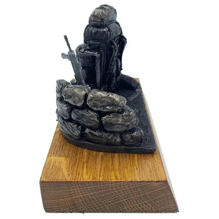 Side profile of Bergen and SA80 bronze resin statue with sandbag wall and rifle, crafted for army memorabilia and home decoration.  from  John Bull Clothing