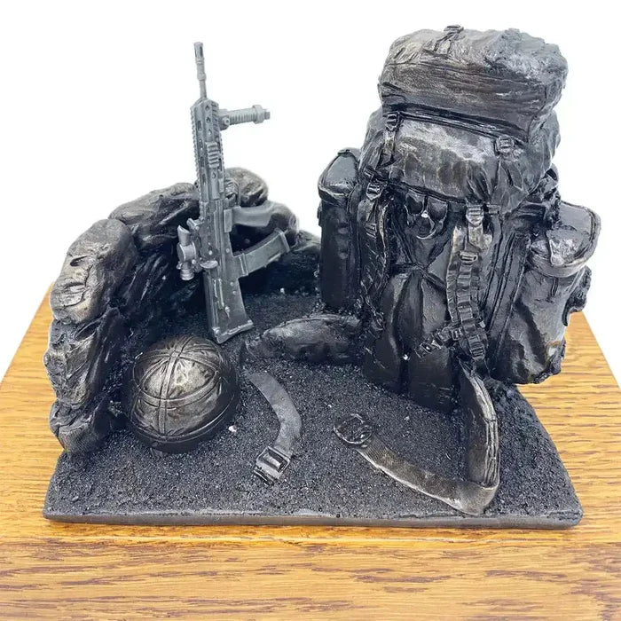 Top view of Bergen and SA80 bronze resin army statue showing helmet, rifle, and backpack on oak base, perfect for military gift or tribute.  from  John Bull Clothing