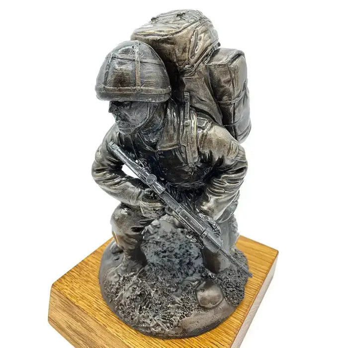 Angled view of Bronze Resin Kneeling Combat Statue with Helmet, depicting armed soldier in combat pose on oak base for home and garden sculpture.  from  John Bull Clothing