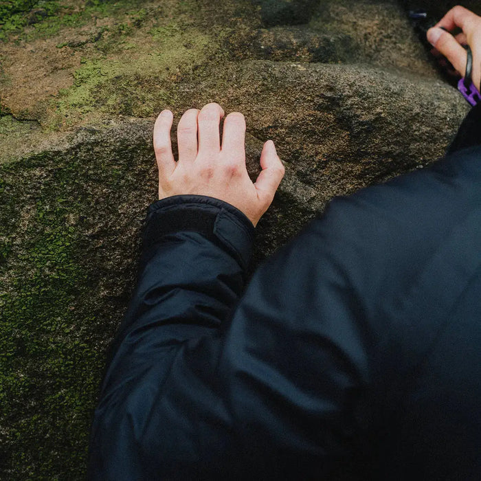 Close-up of Buffalo Mens Pertex Belay Jacket sleeve during rock climbing, highlighting durable Pertex material and weather resistance.  from  John Bull Clothing