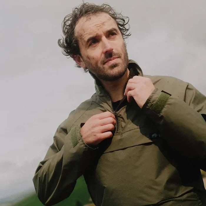Man wearing olive green Buffalo Systems Special 6 Shirt adjusting collar, demonstrating fit and function in outdoor cold weather setting.  from  John Bull Clothing