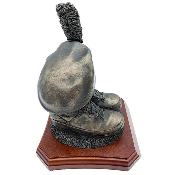 Angled side view of Caubeen and Boots Bronze Resin Statue, capturing realistic boot details and caubeen shape on wood base.  from  John Bull Clothing