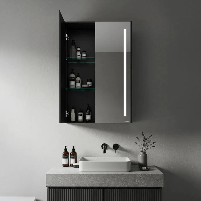 Matte black double door bathroom mirror cabinet with LED strip light and open glass shelves with toiletries - Glazonoid