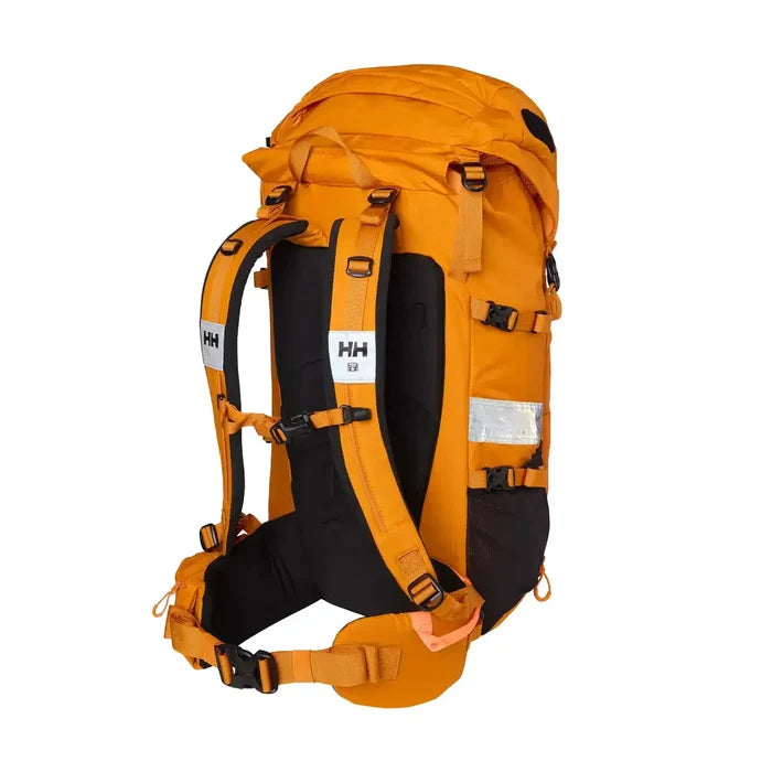 Close-up of orange Helly Hansen Alpine SAR 45 rescue backpack with large main compartment, reflective strips, and adjustable straps  from  John Bull Clothing