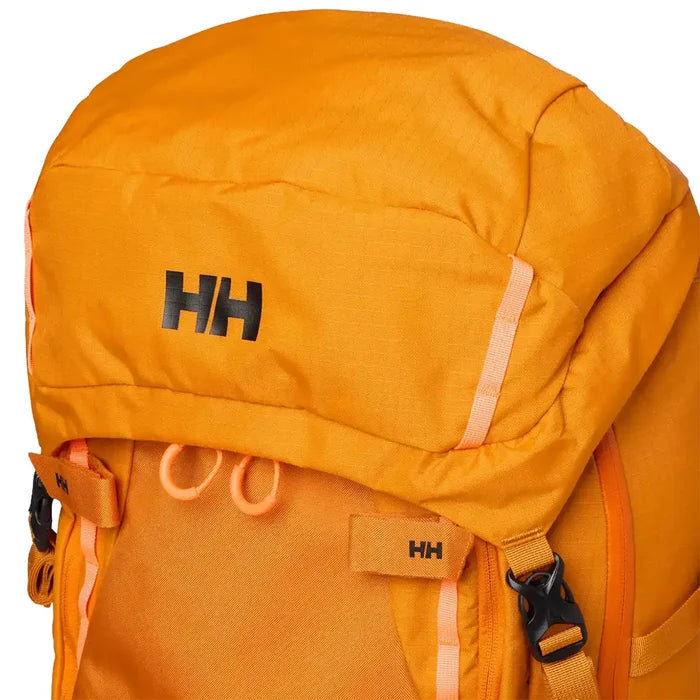 Detail of orange Helly Hansen Alpine SAR 45 rescue backpack with black padded back panel, adjustable waist strap, and reflective accents  from  John Bull Clothing