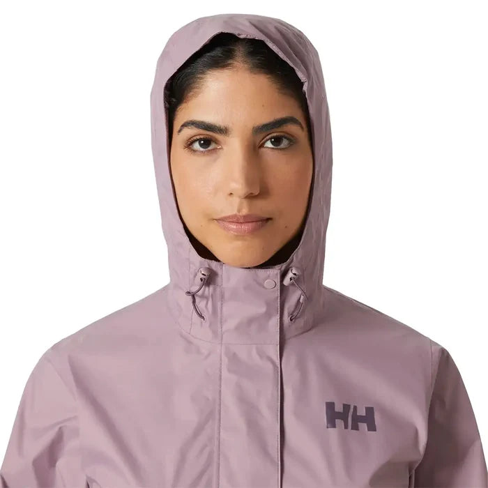 Close-up of model wearing hooded Helly Hansen Womans Loke 2.0 Waterproof Jacket, emphasizing face coverage and collar design.  from  John Bull Clothing