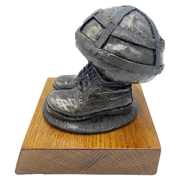 Side view of Helmet & Boots Bronze Resin Statue showing detailed army boots and helmet craftsmanship on oak-finished base.  from  John Bull Clothing