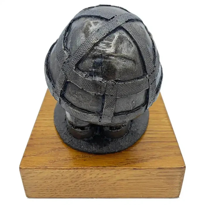 Rear view of Helmet & Boots Statue Bronze Resin | John Bull Clothing, showcasing helmet texture and resin finish on wooden platform.  from  John Bull Clothing