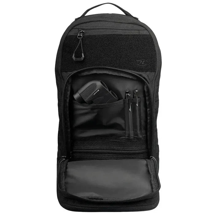 Front compartment of Highlander Harrier 25L Clamshell Rucksack in black, displaying organized storage for essentials like gadgets and stationery.  from  John Bull Clothing