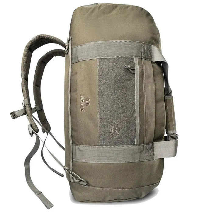 Side view of the Highlander Loader 65L Holdall Bag Gen2 in olive green, highlighting its backpack straps and reinforced construction for heavy loads.  from  John Bull Clothing