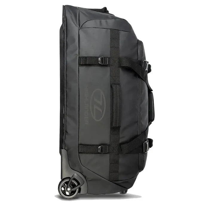 Highlander The Trailer 100 Litre Duffel Bag Black standing upright, featuring heavy-duty straps, robust wheels, and a water-resistant design.  from  John Bull Clothing