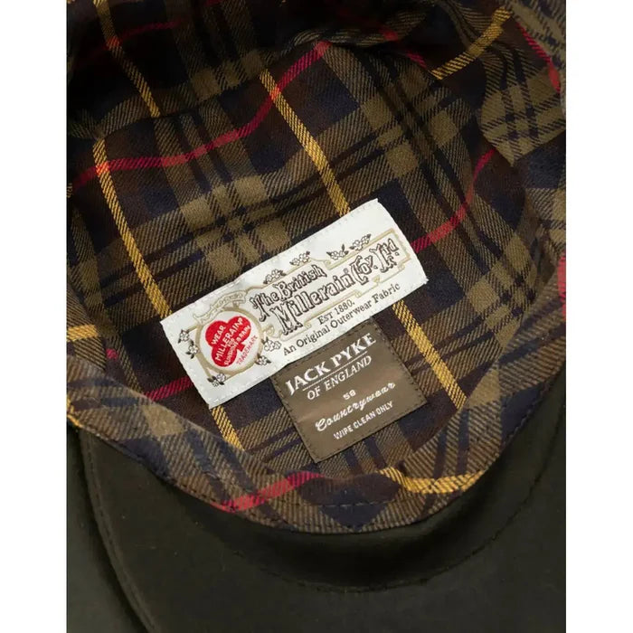 Interior of the Jack Pyke Wax Flat Cap Green, revealing a stylish tartan lining and branded labels for authenticity.  from  John Bull Clothing