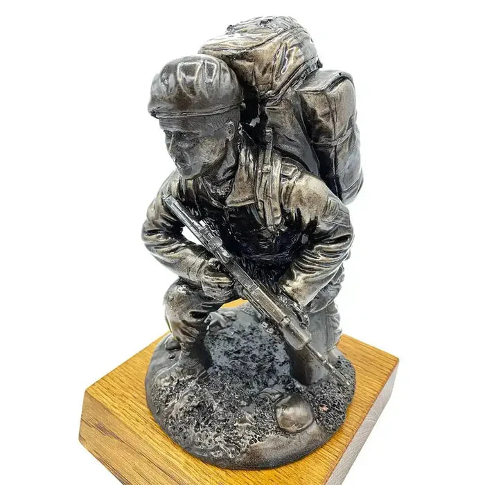 Angled top view of Kneeling Combat Figure with Beret Bronze Statue by John Bulls, highlighting lifelike resin craftsmanship and oak base support.  from  John Bull Clothing