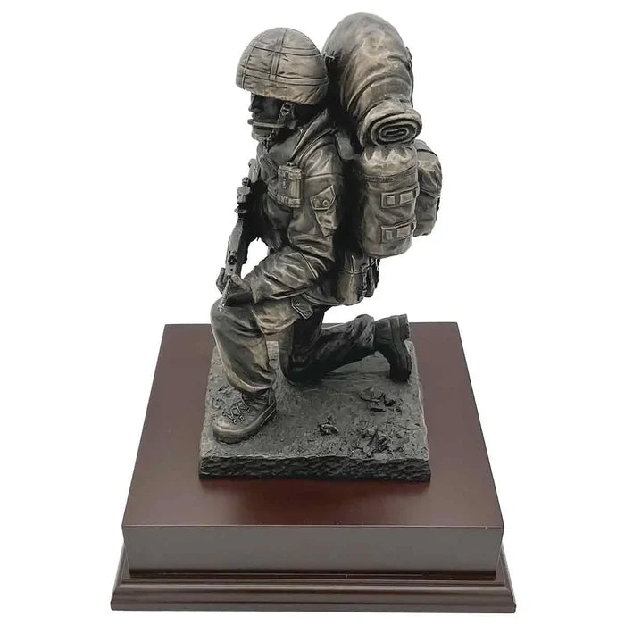 Kneeling Combat Figure with Beret statue in bronze finish, showing soldier in action-ready pose with full combat equipment on wooden base.  from  John Bull Clothing