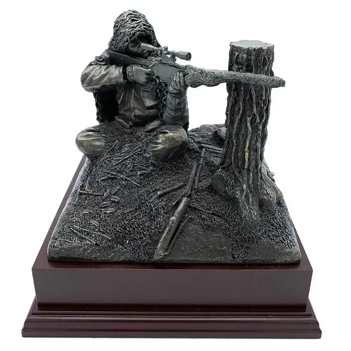 Kneeling Sniper Bronze Resin Figurine | John Bull Clothing features a camouflaged sniper aiming from behind a tree stump, mounted on a rosewood base.  from  John Bull Clothing