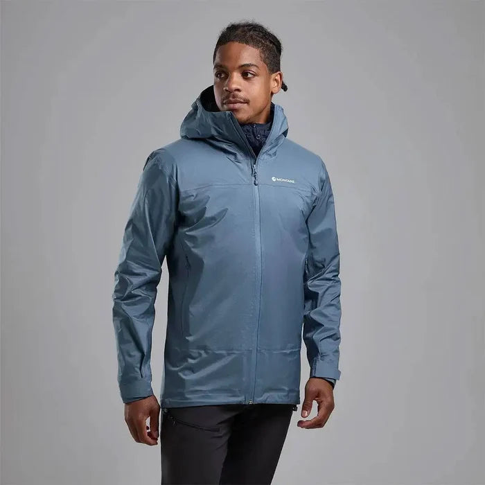 Model wearing Montane Mens Cetus Lite Waterproof Jacket in blue, showcasing its stylish and functional design for wet and windy conditions.  from  John Bull Clothing