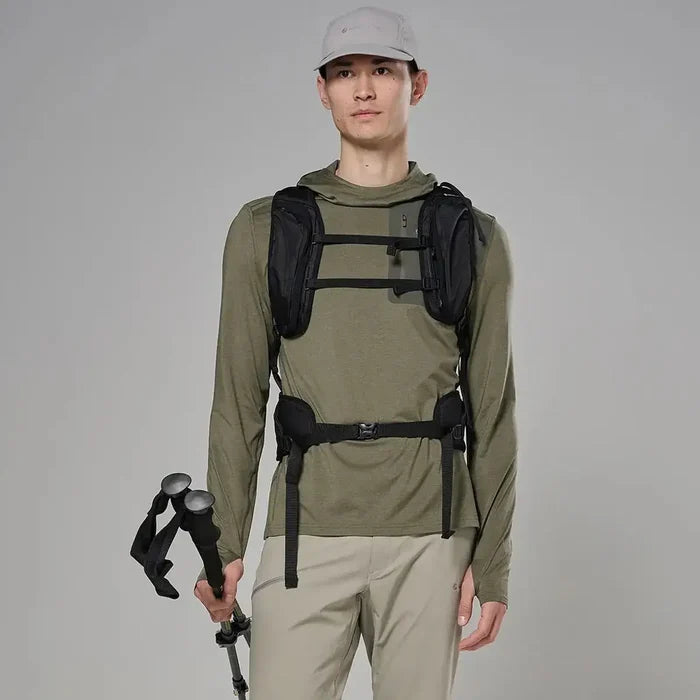 Male model wearing olive green hooded outdoor jacket with long sleeves, adjustable cuffs, and a front zipper, holding trekking poles
