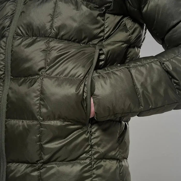 Close-up of a dark green puffer jacket with quilted sections, zipper closure, and a side pocket, designed for outdoor warmth and insulation