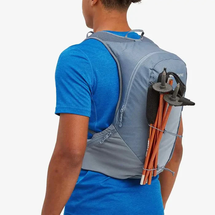 Montane Trailblazer 18L Backpack with trekking poles attached, highlighting its versatile storage options for outdoor gear.  from  John Bull Clothing
