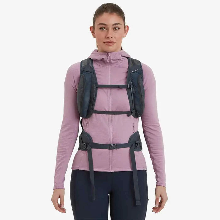 Woman wearing Montane Trailblazer 24L Womens Rucksack, showcasing its ergonomic fit, chest straps, and front storage pockets for easy access.  from  John Bull Clothing