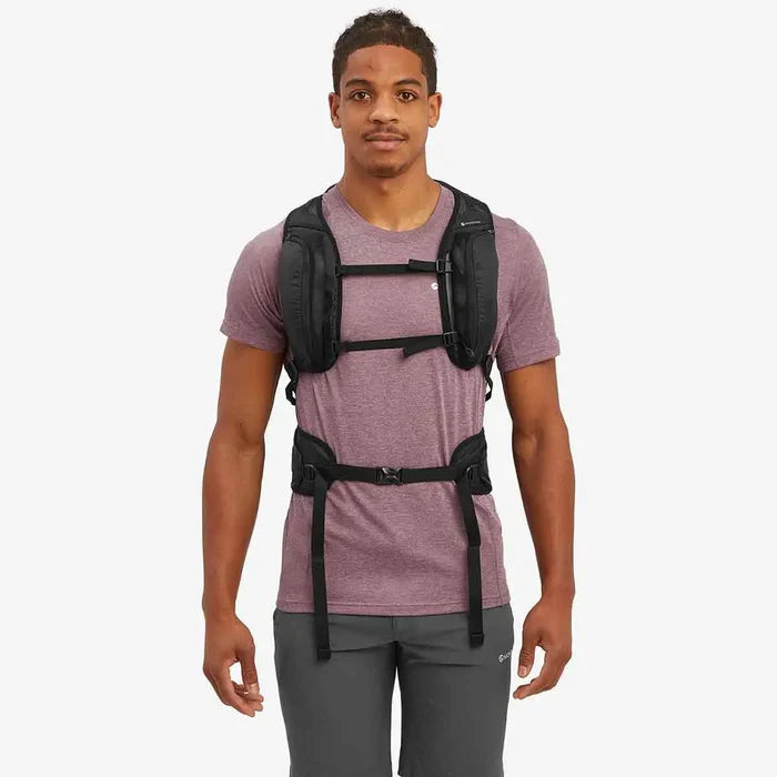 Front view of a model wearing the Montane Trailblazer 25L Rucksack in black, showcasing its adjustable chest and waist straps.  from  John Bull Clothing