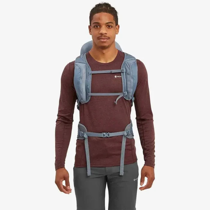 Model wearing the Montane Trailblazer 32 Litre Backpack in blue, highlighting the adjustable chest and waist straps for a secure and comfortable fit.  from  John Bull Clothing