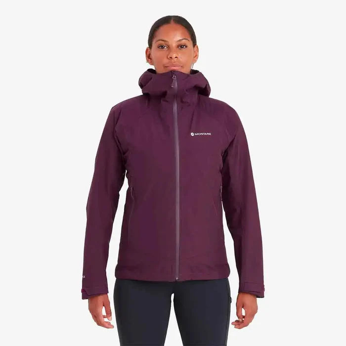 Model wearing Montane Womens Spirit Waterproof Jacket in purple. A lightweight, breathable raincoat for outdoor activities.  from  John Bull Clothing