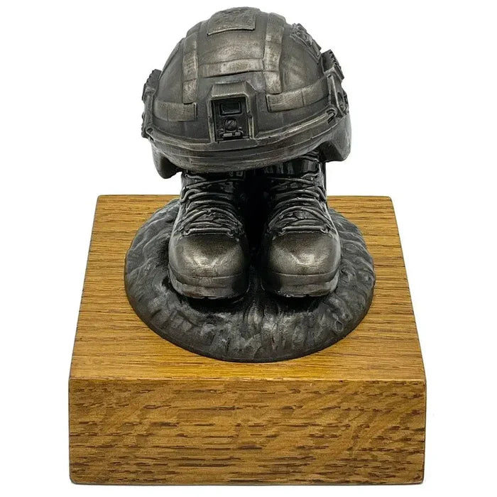 Front view of Helmet and Boots Statue Bronze Resin with lifelike army helmet and boots on a wooden plinth, ideal for military collectors.  from  John Bull Clothing