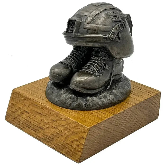 Angled view of Helmet and Boots Statue Bronze Resin highlighting intricate boot laces and helmet straps, perfect for army-themed decor.  from  John Bull Clothing