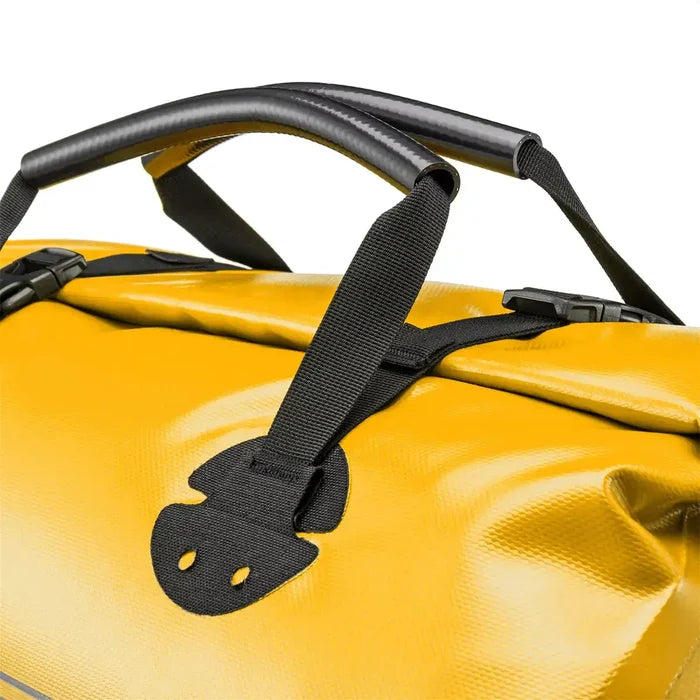 Close-up of yellow Ortlieb Rack Pack 31L Waterproof Duffle Bag handle showing padded grip and reinforced stitching for durability.  from  John Bull Clothing