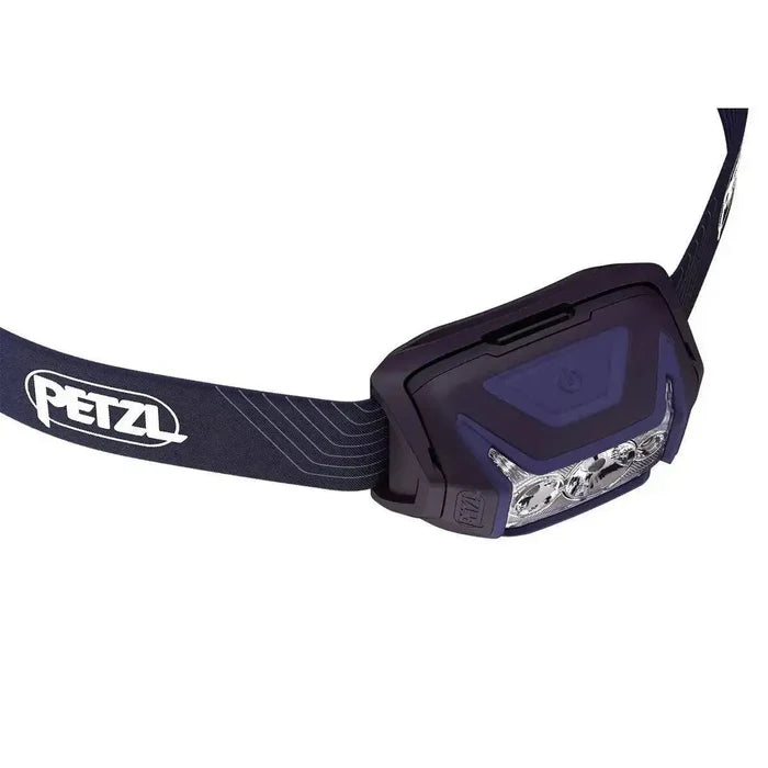 Close-up of the Petzl Actik Headtorch with Red Lighting 450 Lumens in dark blue, highlighting its ergonomic design and powerful LED lights.  from  John Bull Clothing