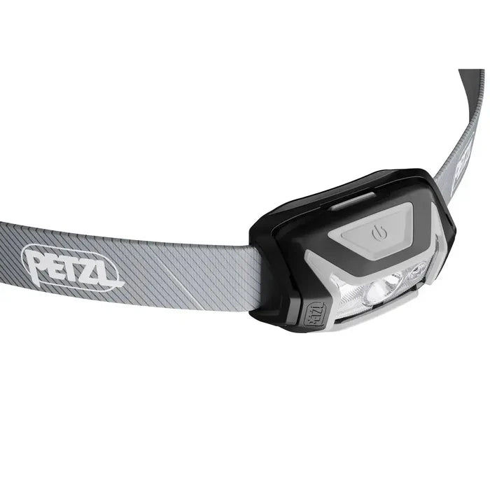 Angled view of Petzl Tikka Core Headtorch with Red Light 450 Lumens in grey, highlighting power button and lens design.  from  John Bull Clothing