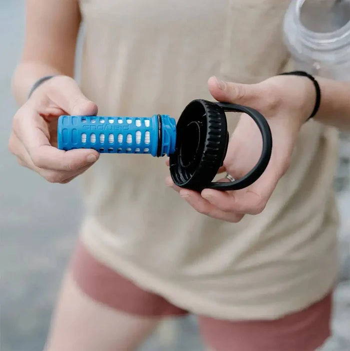Hands holding Platypus DayCap In Water Bottle Filter, showcasing its detachable filtration system for easy cleaning and use.  from  John Bull Clothing