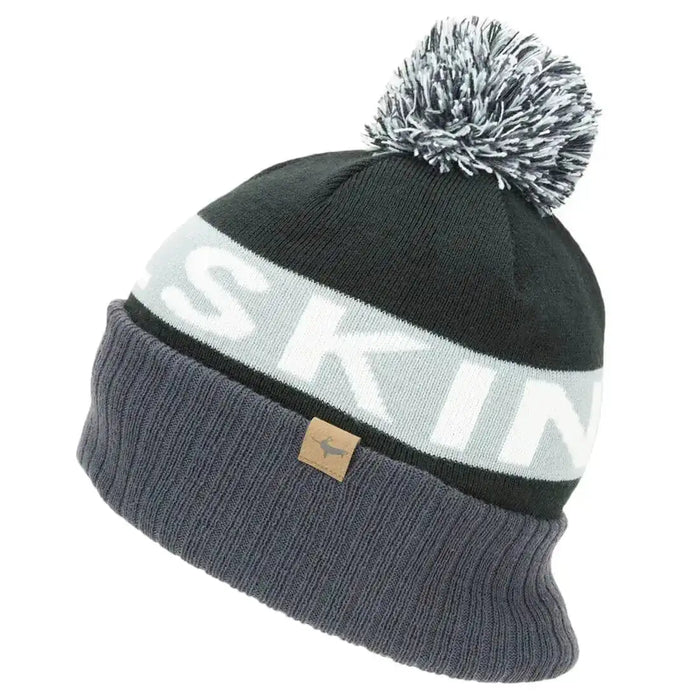Sealskinz Foulden Water Repellent Cold Weather Bobble Beanie in black and gray, designed for warmth and protection against cold and damp conditions. Grey from  John Bull Clothing