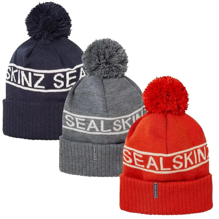 Sealskinz Heacham Waterproof Cold Weather Icon Bobble Hat in navy, grey, and red, ideal winter headwear for adults seeking warmth and style.  from  John Bull Clothing