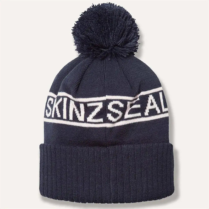 Rear view of navy Sealskinz Heacham Waterproof Cold Weather Icon Bobble Hat with ribbed cuff and bold white logo band.  from  John Bull Clothing