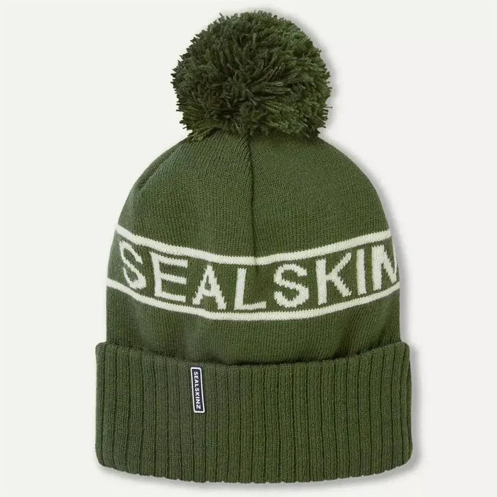 Olive green Sealskinz Heacham Waterproof Cold Weather Icon Bobble Hat with white branding and pom-pom, ideal for outdoor winter wear.  from  John Bull Clothing