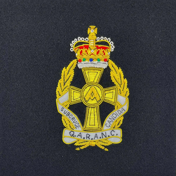 Embroidered Q.A.R.A.N.C. regiment badge with gold detailing and a crown emblem. Perfect for military presentation frames and memorabilia collections. QARANC from  John Bull Clothing