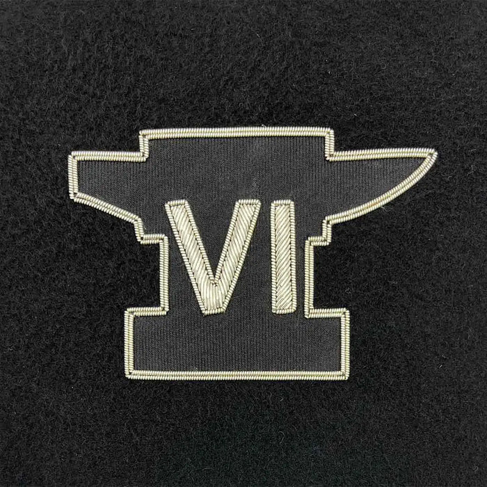 Embroidered military insignia featuring a black anvil with Roman numeral VI in silver thread. Ideal for Army presentation frames and memorabilia. Anvil REME from  John Bull Clothing