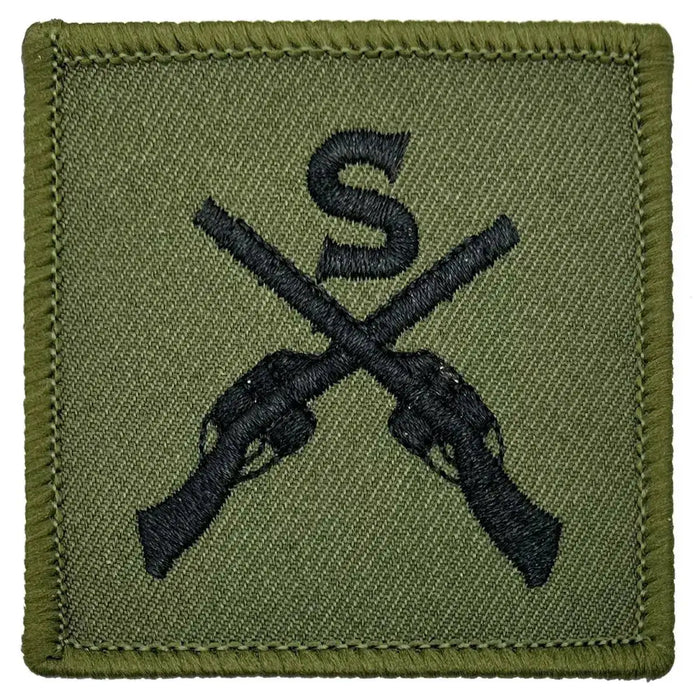 Close-up of Sniper Trade TRF - Iron On Patch | John Bull Clothing showing detailed embroidery of black crossed rifles and 'S' on green cotton fabric. 1 Flash from  John Bull Clothing