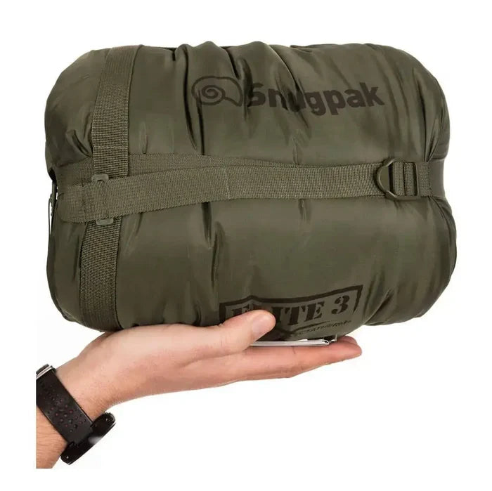 Compressed Snugpak Softie Elite 3 Sleeping Bag Olive Green in stuff sack with hand for scale, perfect for portable outdoor adventures.  from  John Bull Clothing